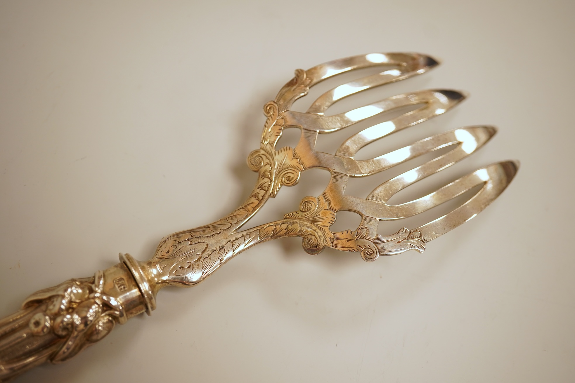 A pair of Victorian ornate silver fish servers, by John Gilbert, Birmingham, 1864, 34.1cm.